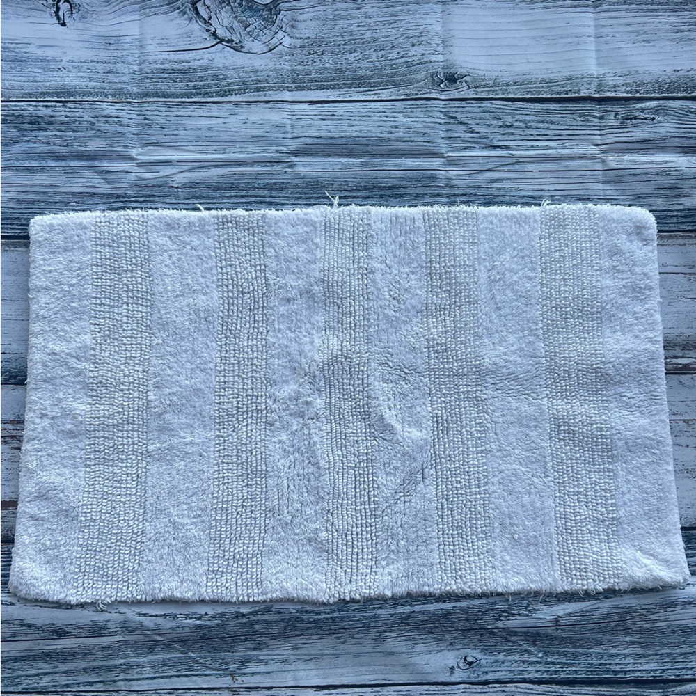 DKNY white bathroom rug 33in x 19in EUC